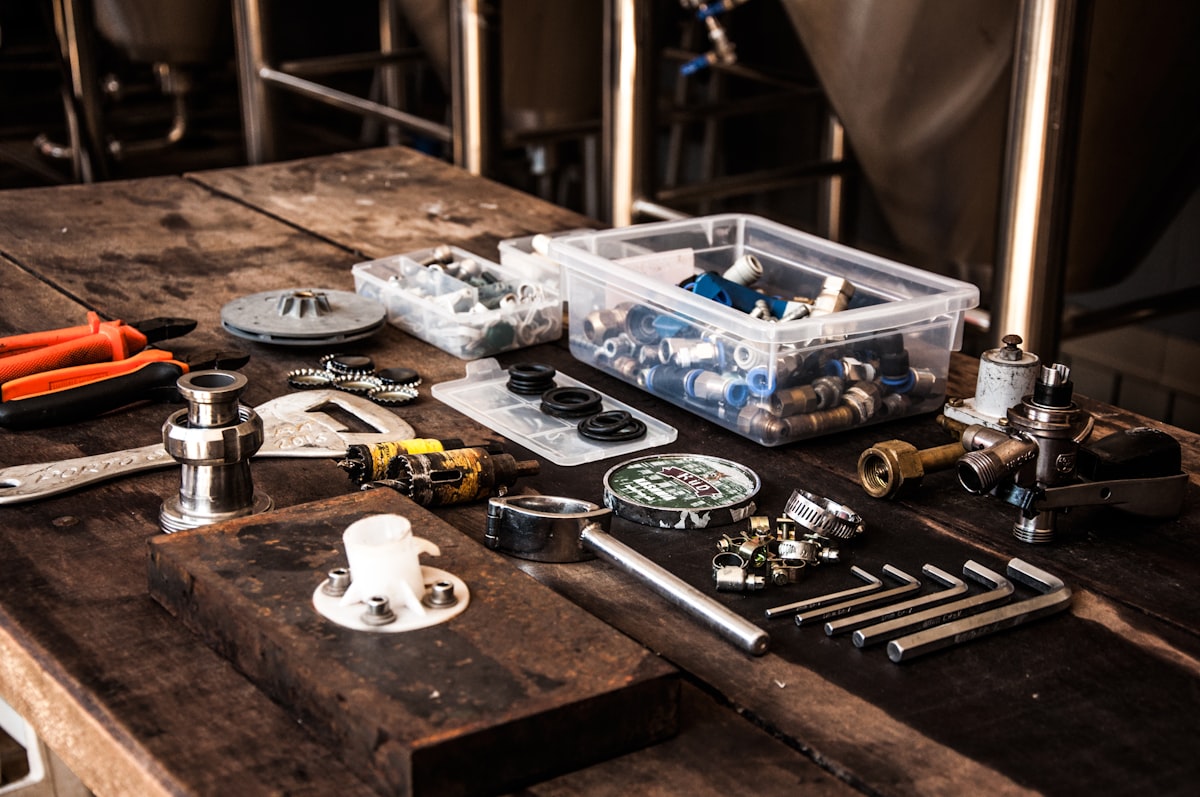 Plumbing tools and fittings laid out on a workbench